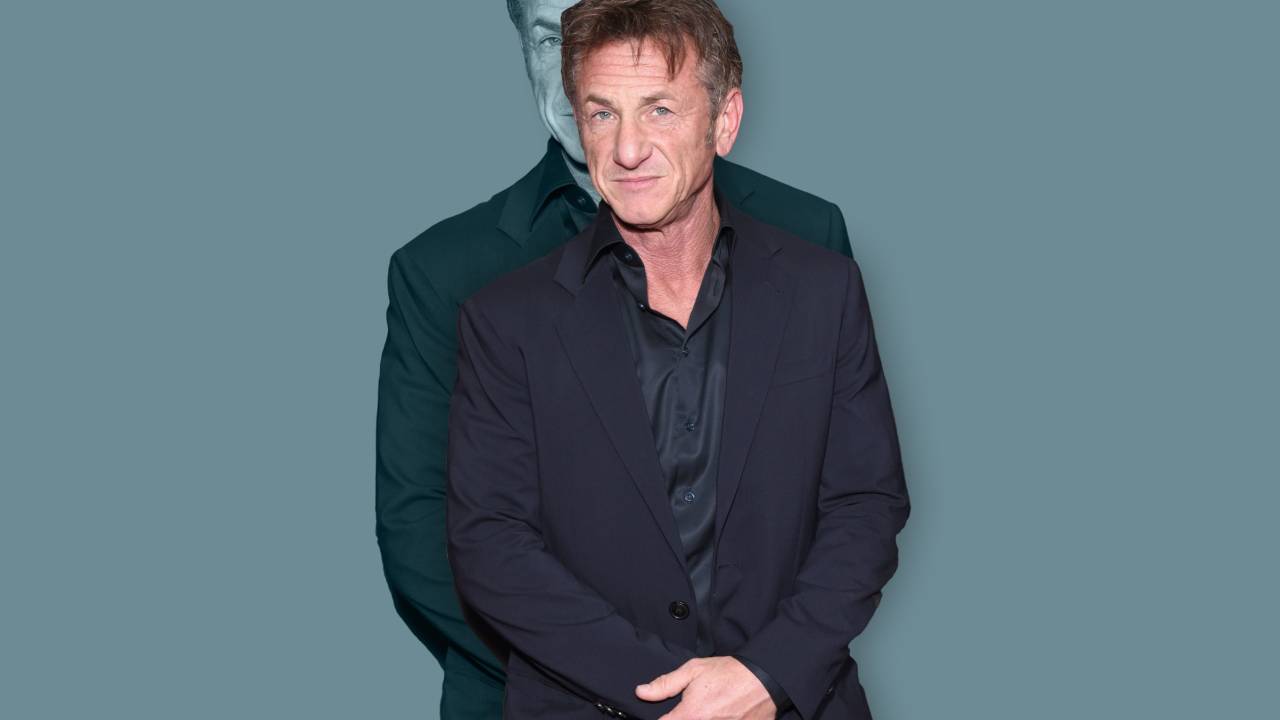 A imagem mostra o ator Sean Penn, de terno e camisa escuros