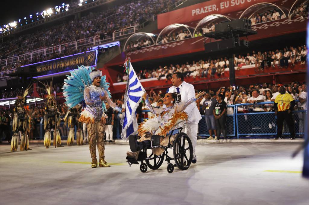 Com dedo quebrado, Porta-bandeira da Portela desfila de cadeira de rodas