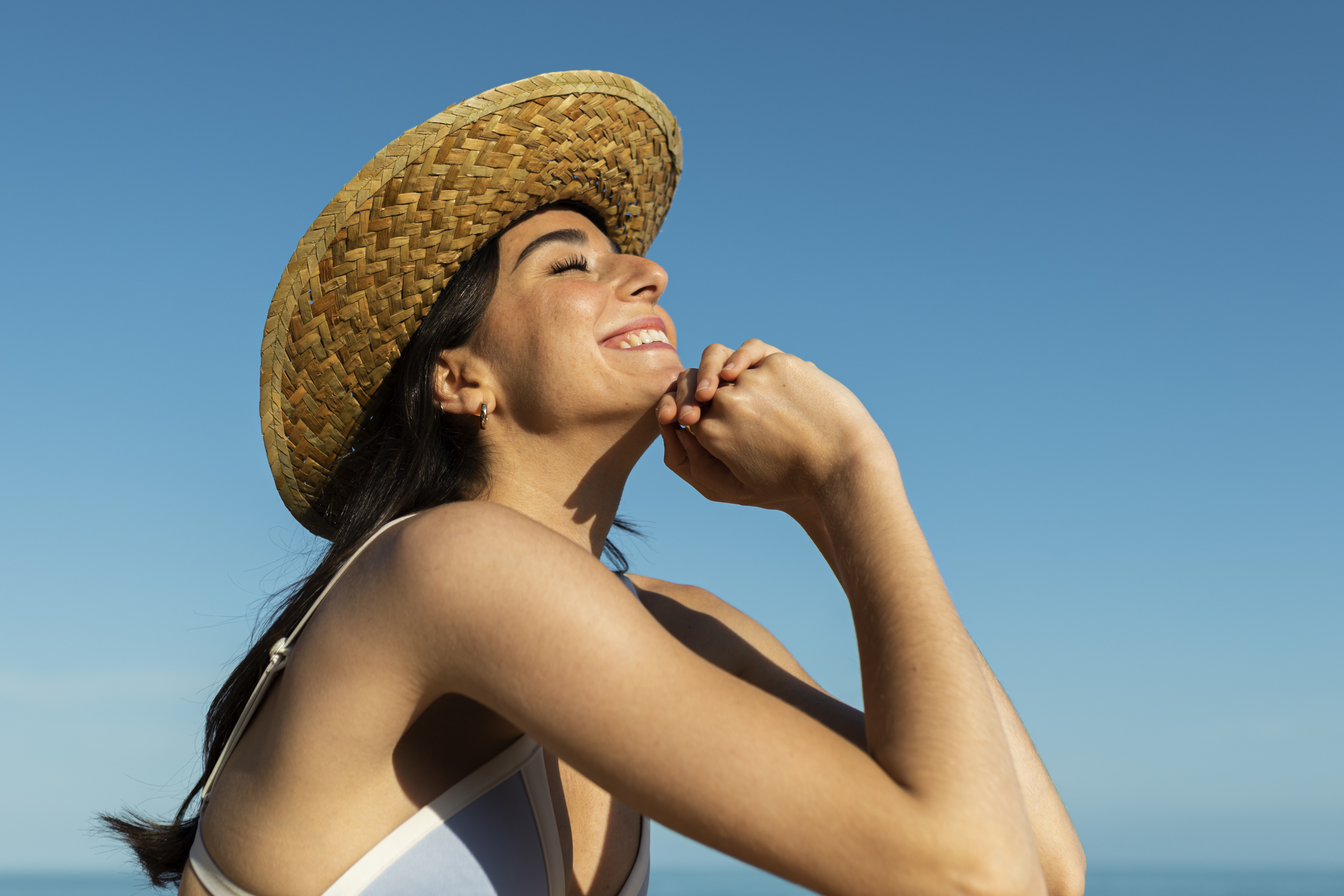 smiley-woman-posing-beach-side-view